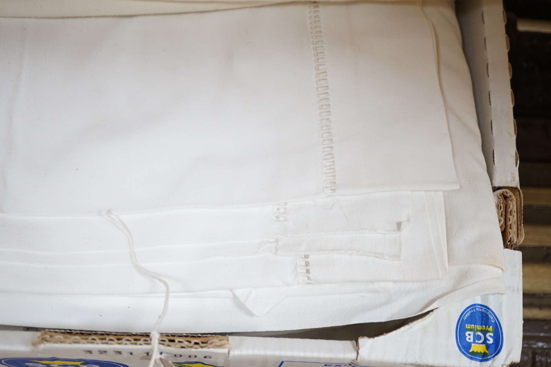 A quantity of French provincial linen sheets, some with monograms and button holed turn back